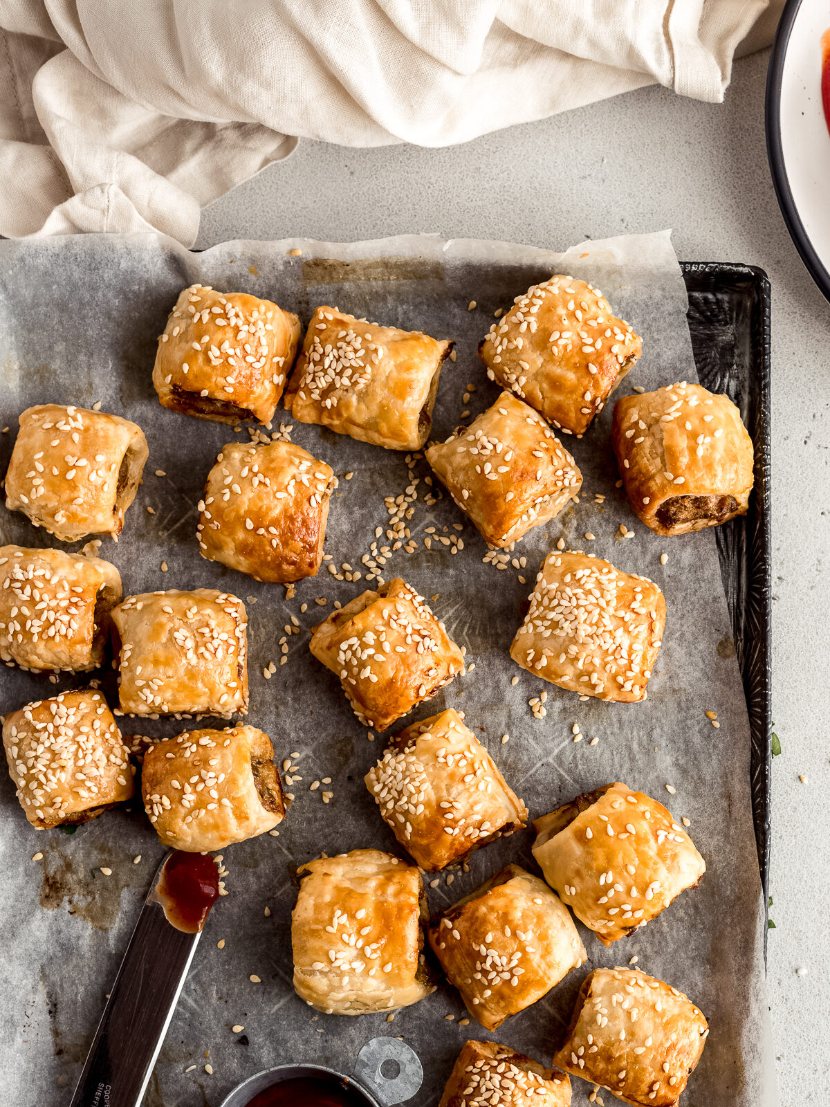 Homemade sausage rolls on a large vintage tray.