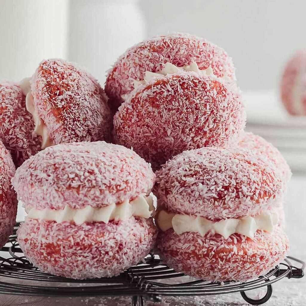 Old fashioned jelly cakes made with soft sponge, raspberry jelly and coconut, filled with chantilly cream