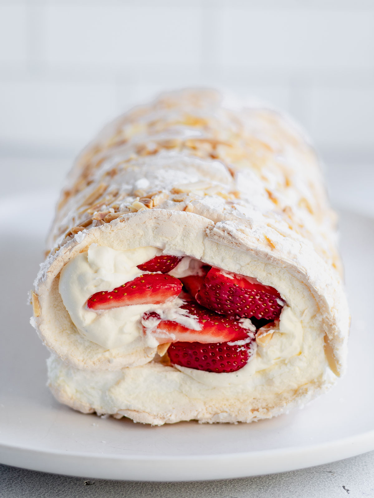 A rolled pavlova, filled with chantilly cream and strawberries.
