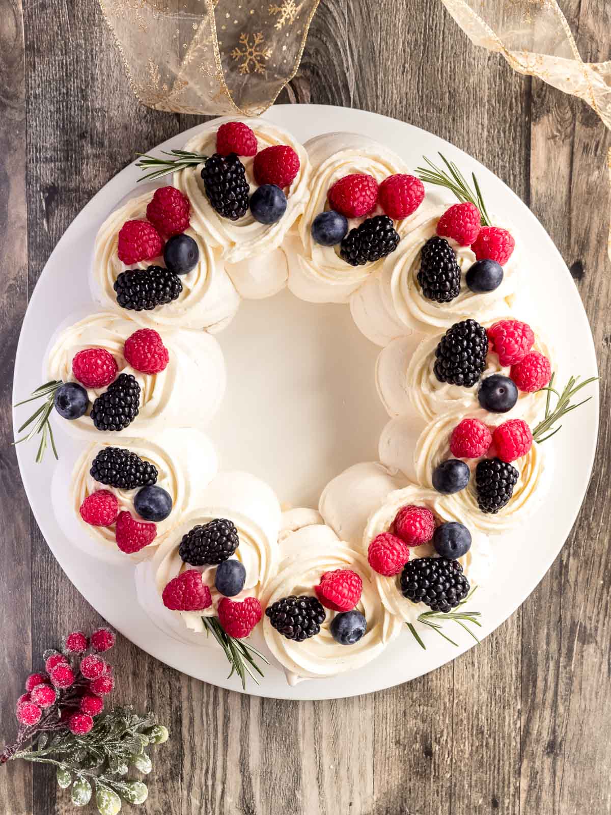 Decorate your Christmas pavlova wreath with Chantilly cream and fresh berries.