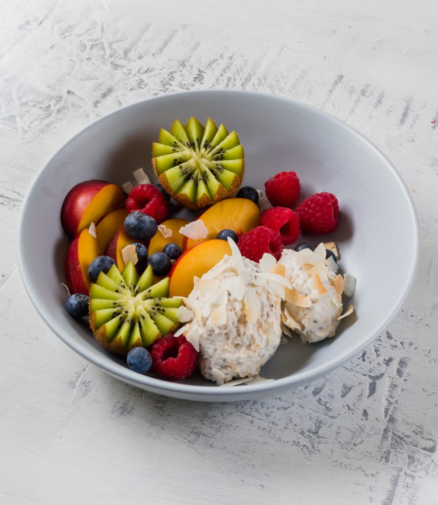 overnight oats and fresh fruit in blue bowl