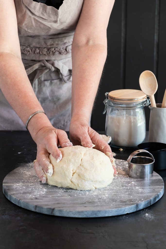 rolling scone dough onto floured surface