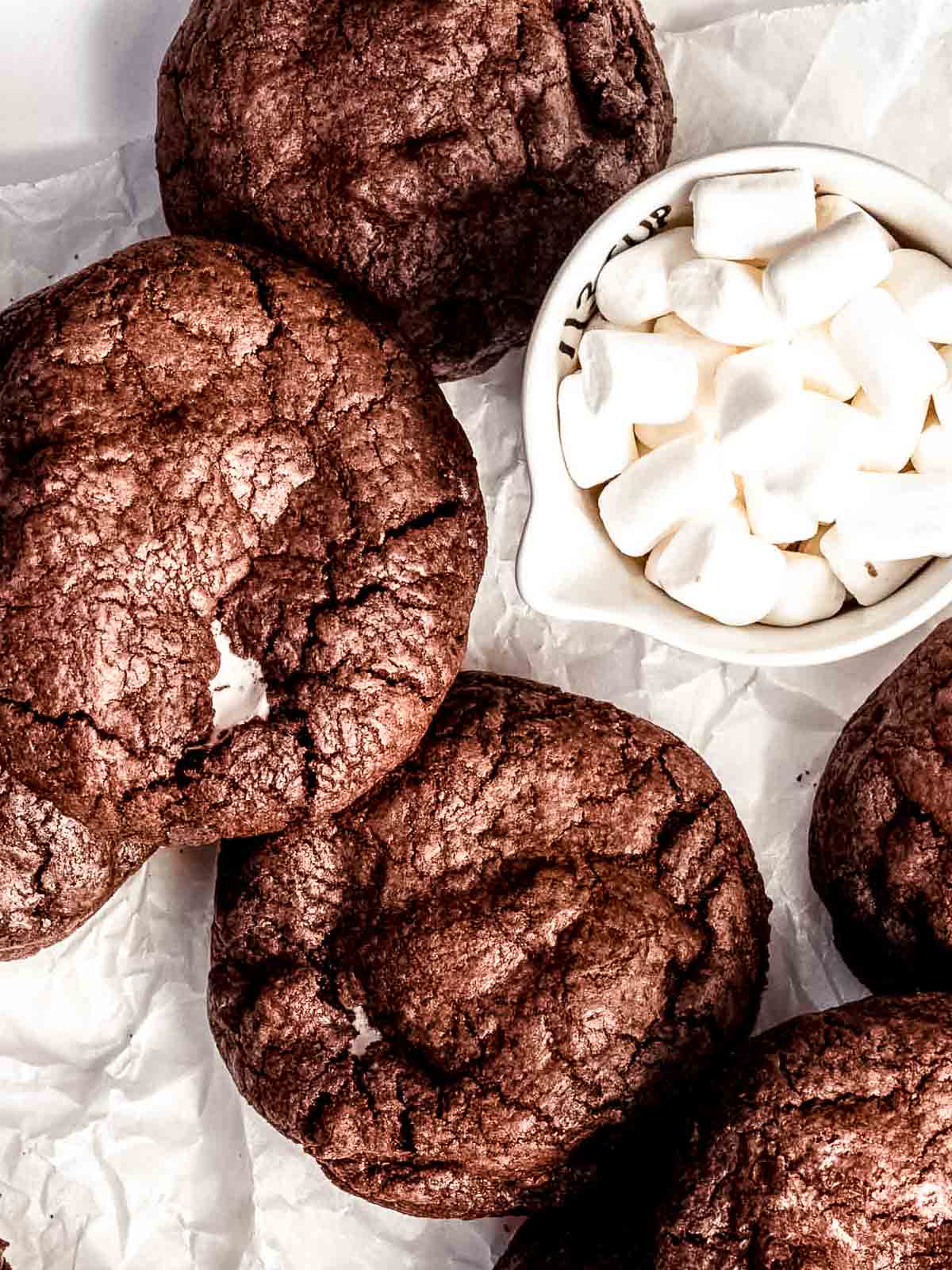 Stack of chewy chocolate marshmallow cookies with gooey centres and crisp edges, fresh from the oven.