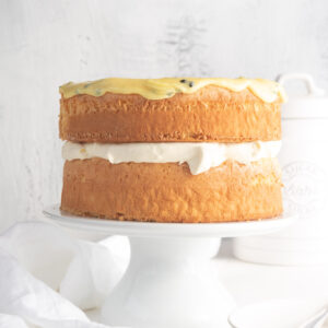 A fluffy and light traditional sponge cake, filled with cream and topped with passionfruit icing.