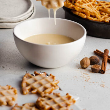 dipping waffle bites into glaze