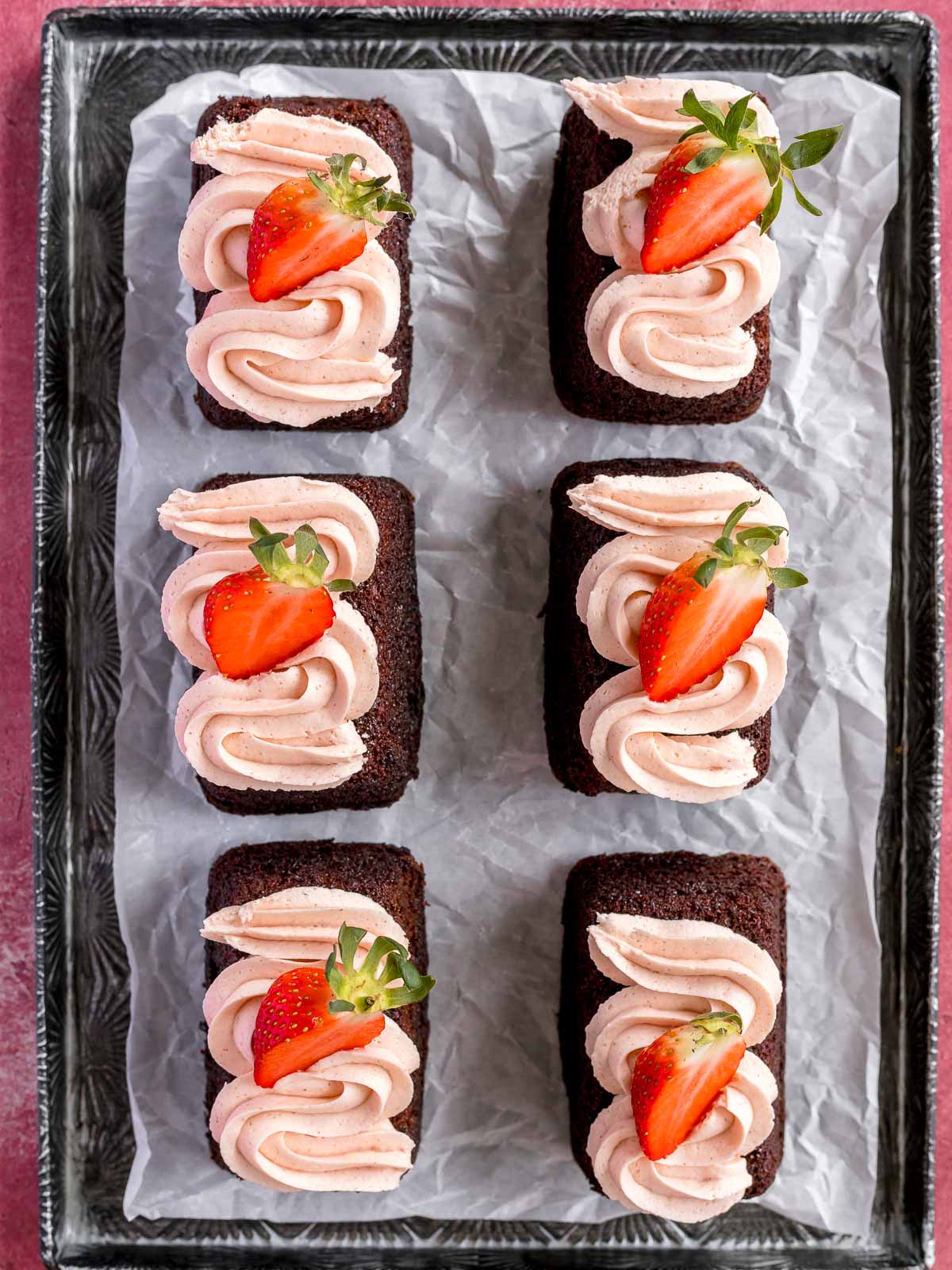 Mini chocolate cakes with fresh strawberry frosting.