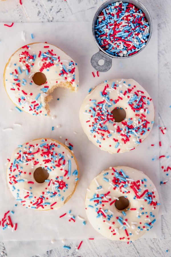 overhead shot of 4 glazed donuts with sprinkles