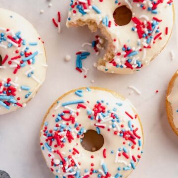 overhead shot of glazed donuts with a bite out of one