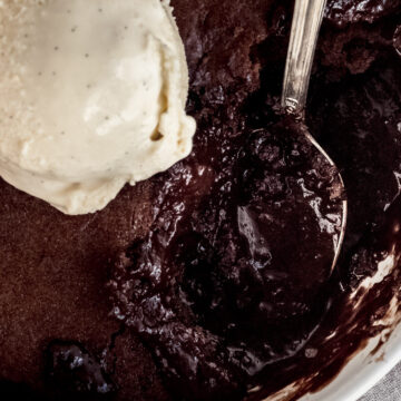 close up of chocolate self-saucing pudding and a scoop of vanilla ice cream.