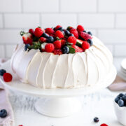 How to make a perfect pavlova, with a crisp shell and marshmallow centre, topped with cream and berries.