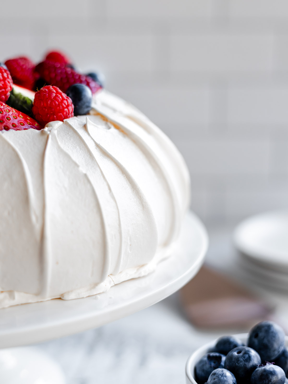 How to make a perfect pavlova, with a crisp shell and marshmallow centre, topped with cream and berries.