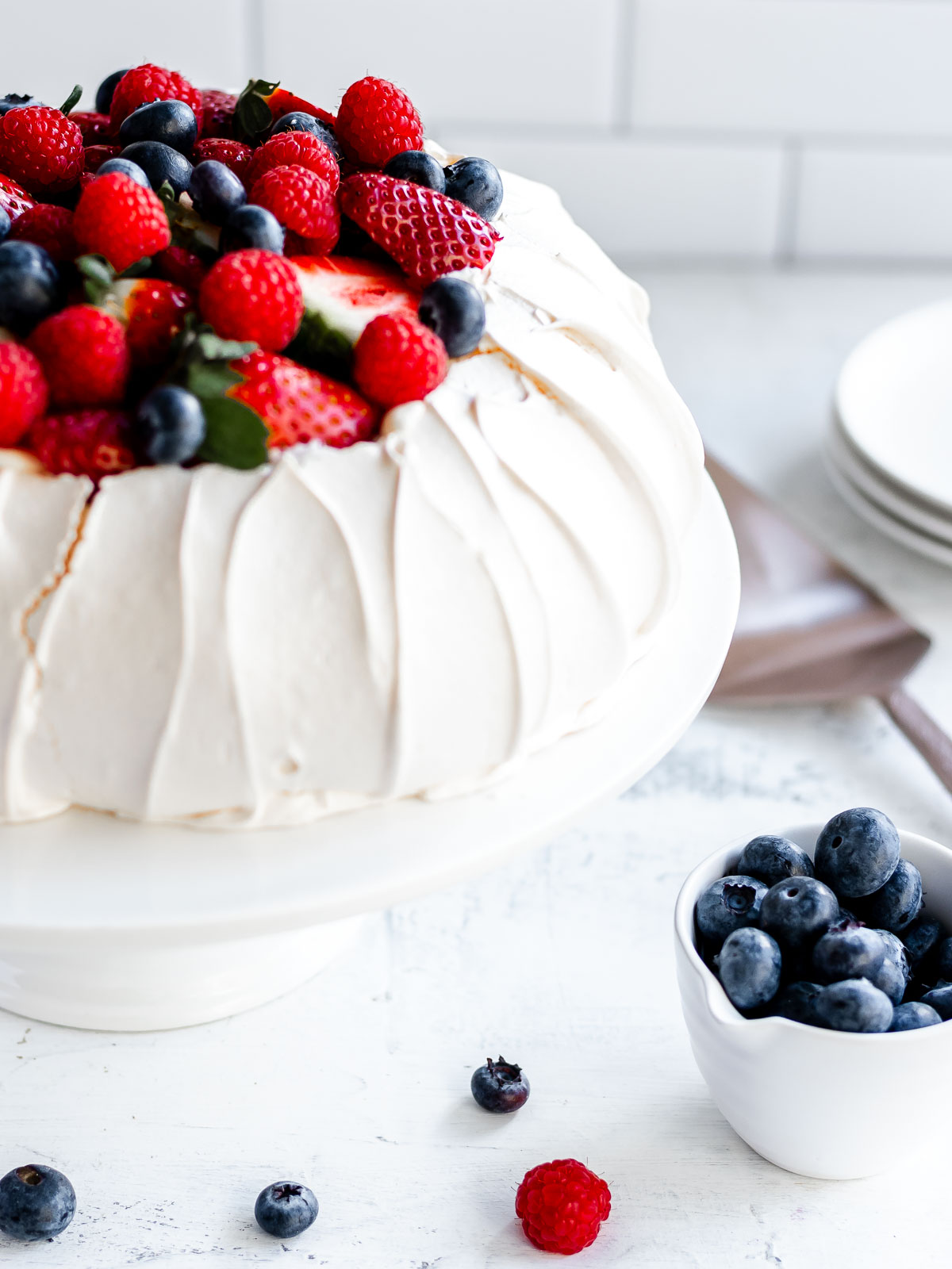 How to make a perfect pavlova, with a crisp shell and marshmallow centre, topped with cream and berries.