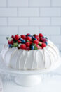 How to make a perfect pavlova, with a crisp shell and marshmallow centre, topped with cream and berries.