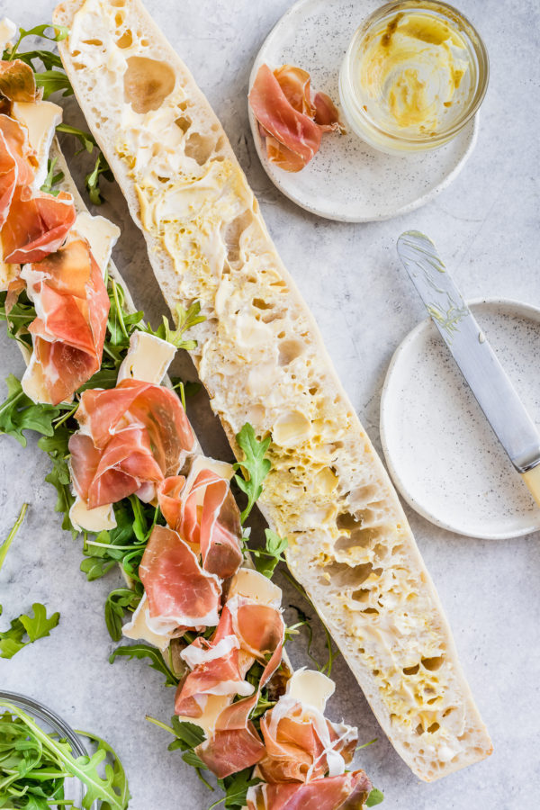 baguette with rocket, brie cheese and prosciutto