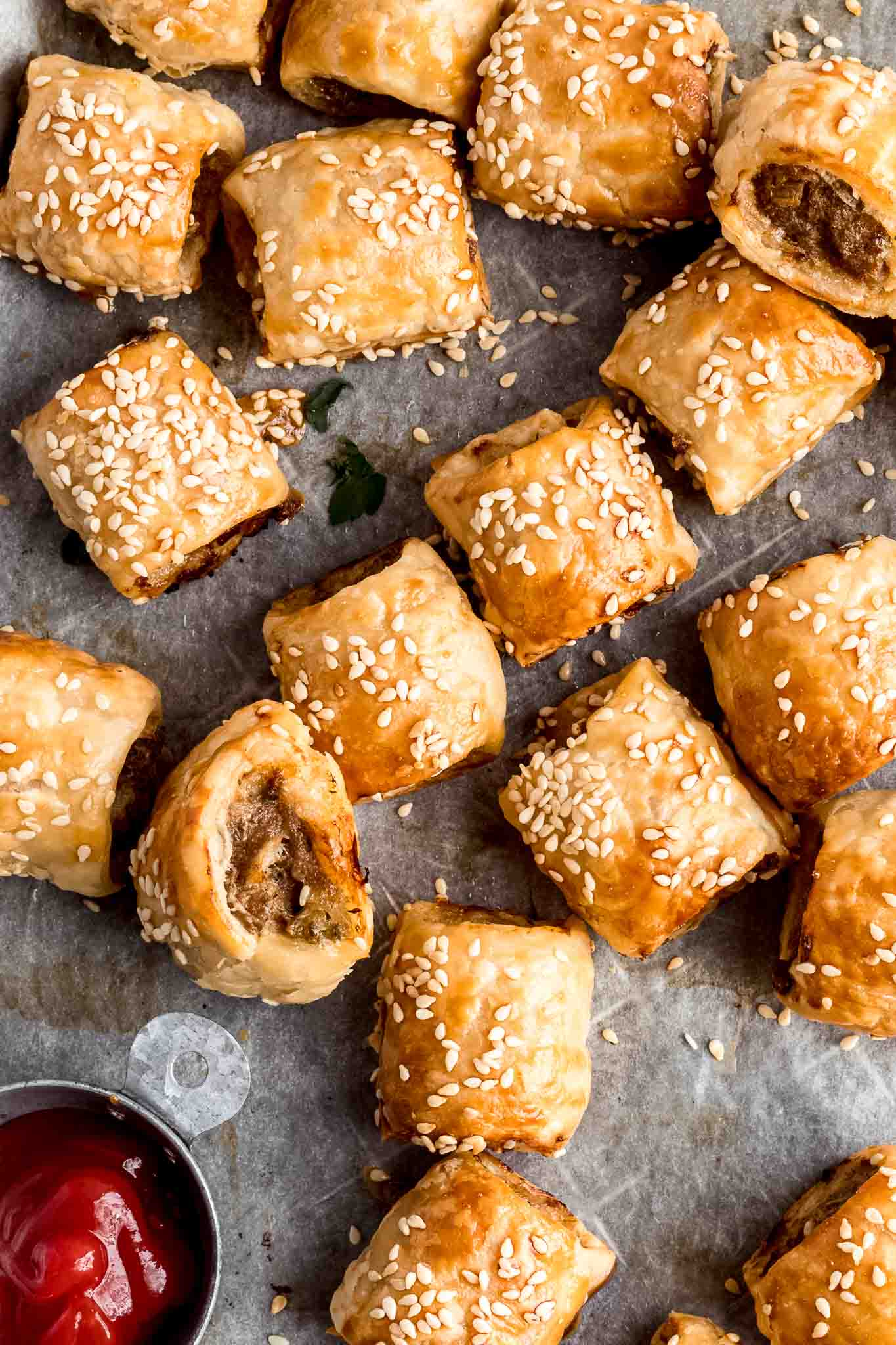 close up of sausage rolls with sauce