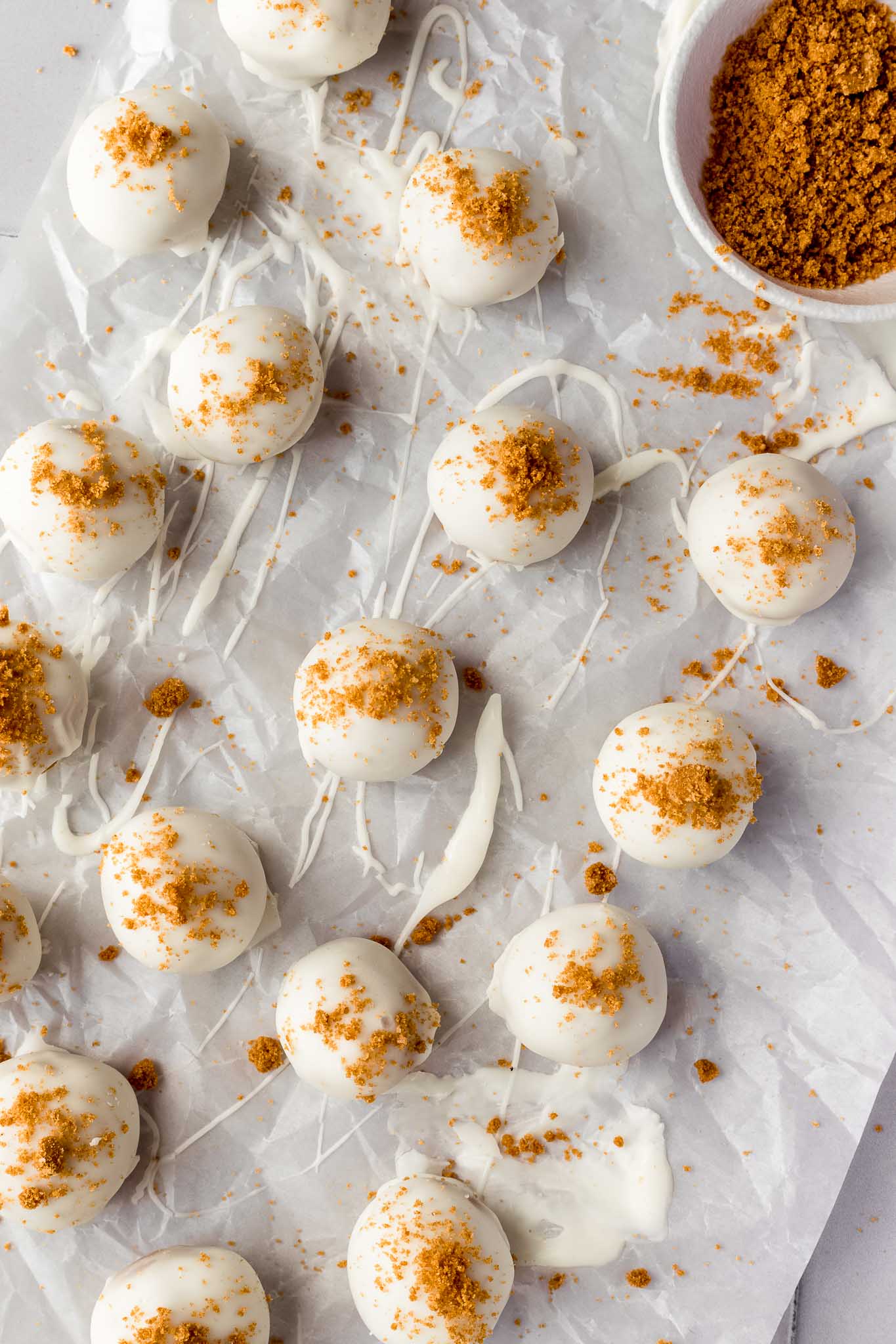 overhead shot of white chocolate truffles, sprinkled with cookie crumbs