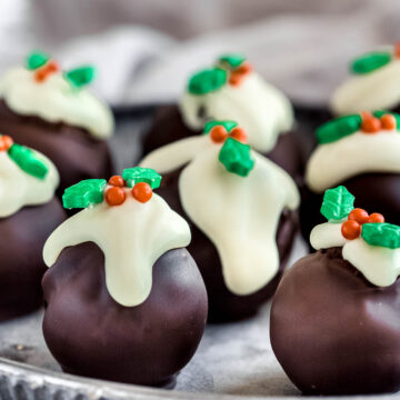 close up of mini christmas pudding truffles on a round vintage tray