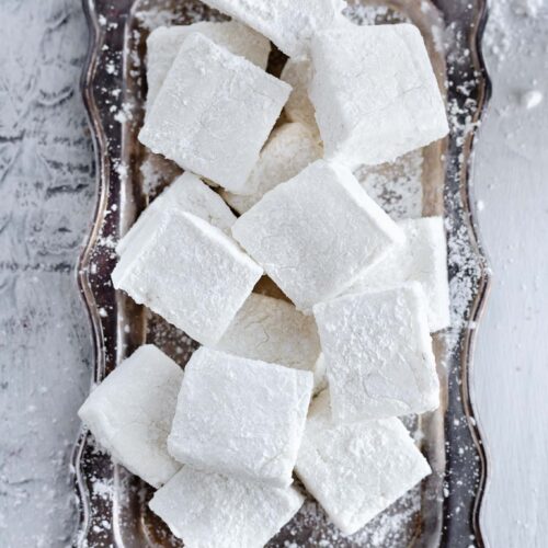 homemade vanilla marshmallows squares on a vintage tray