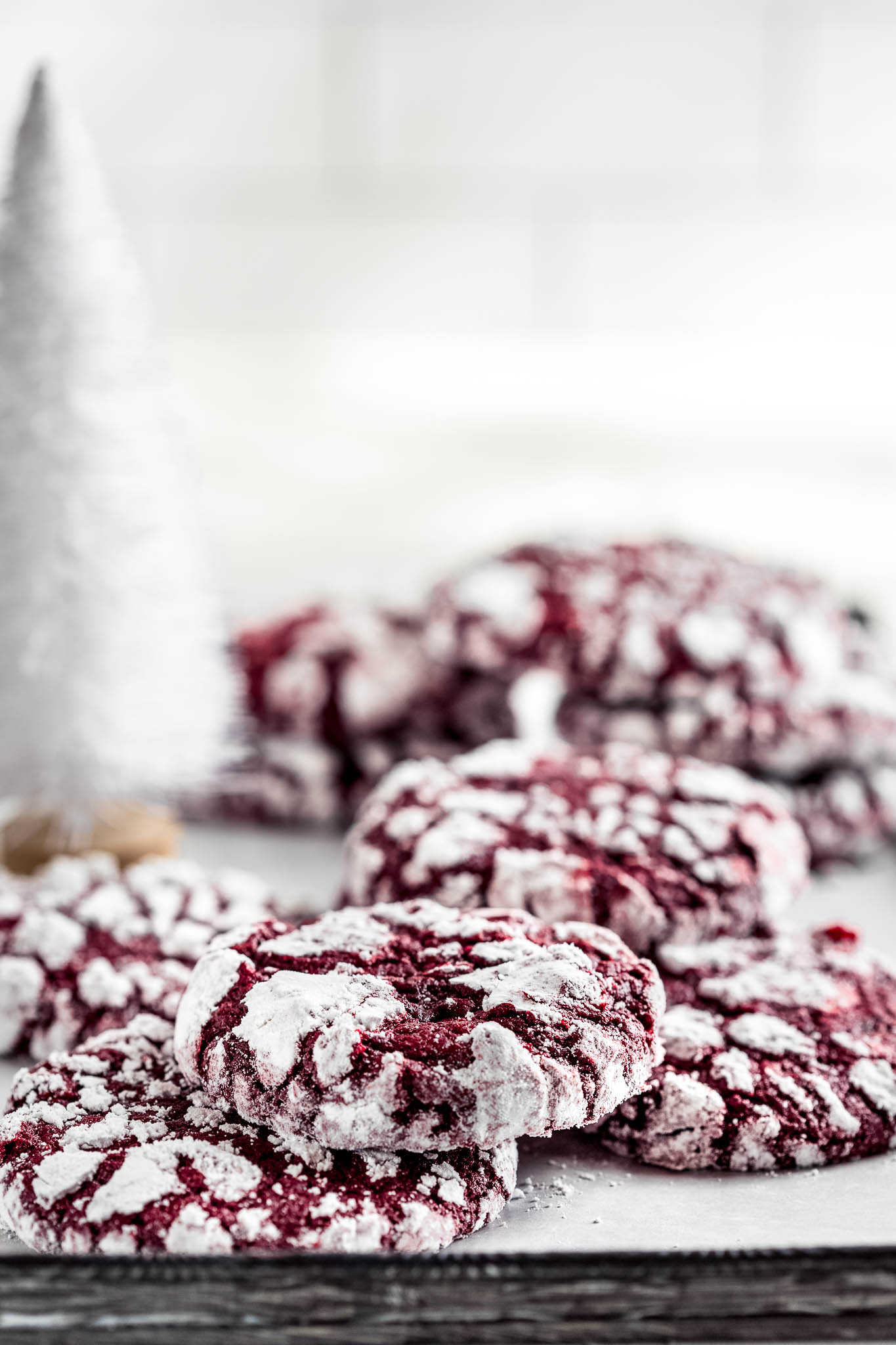 crinkle cookies on a tray with a white christmas tree ornament