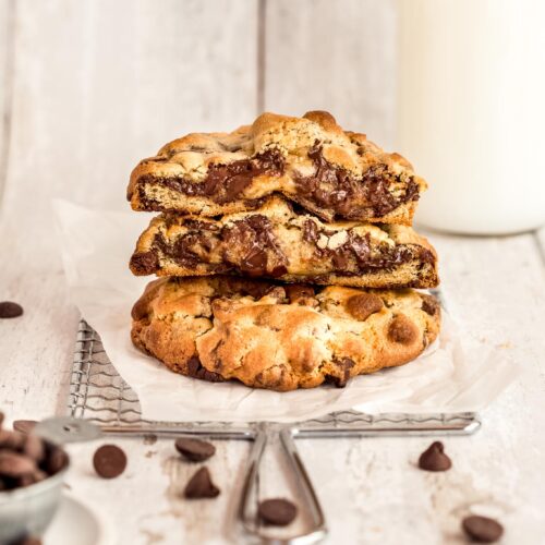stack of 3 cookies, with 2 cut in half to show their gooey centres