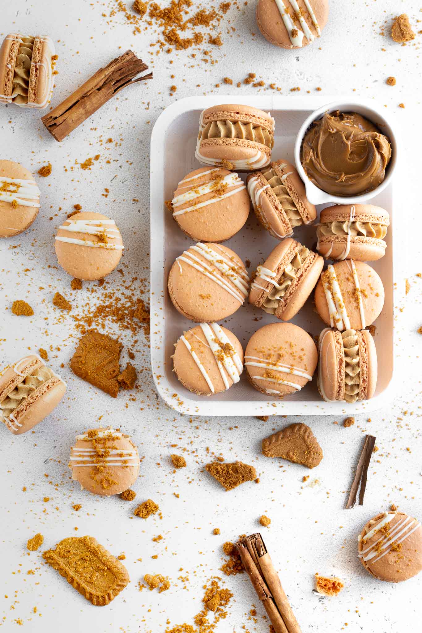 Biscoff macarons on a white timber tray