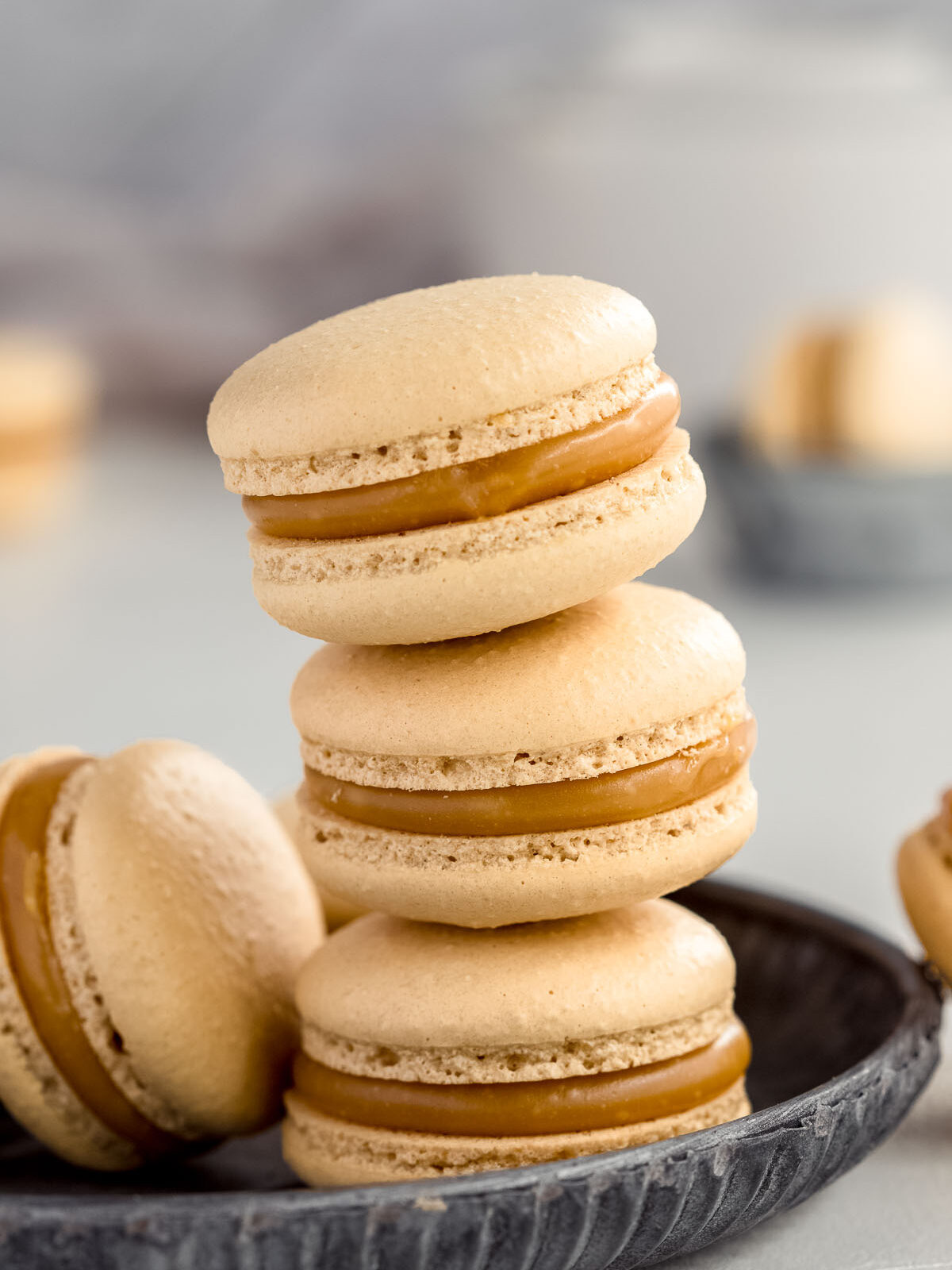 a tray of caramel French macarons on a tray