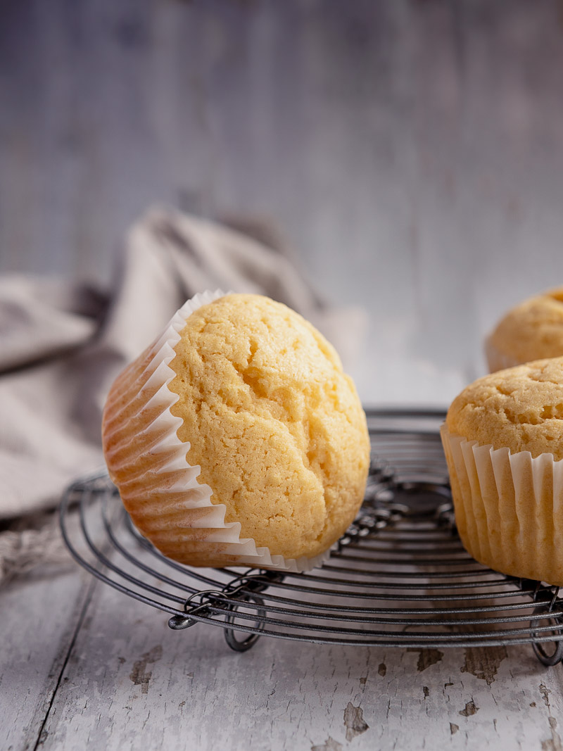 close up shot of a little cupcake (patty cake) sitting on it's side, on top of a cooling rack