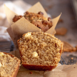 biscoff muffin cut in half to show the white chocolate chips inside