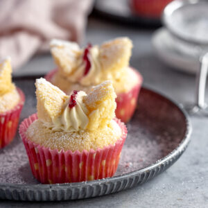 2 butterfly cakes filled with whipped cream and jam