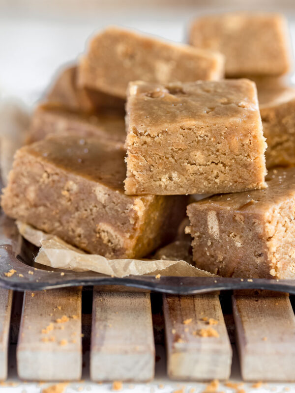 close up shot of caramel slice stacked on a tray