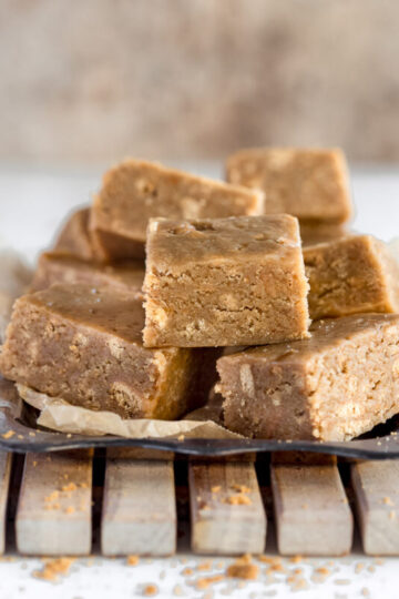 Squares of easy caramel slice stacked on a plate.