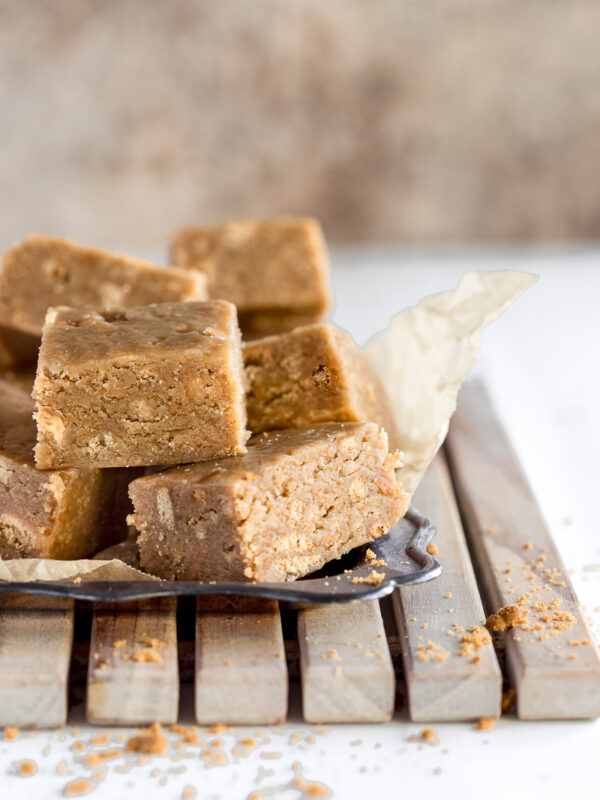 close up shot of squares of caramel slice on a tray