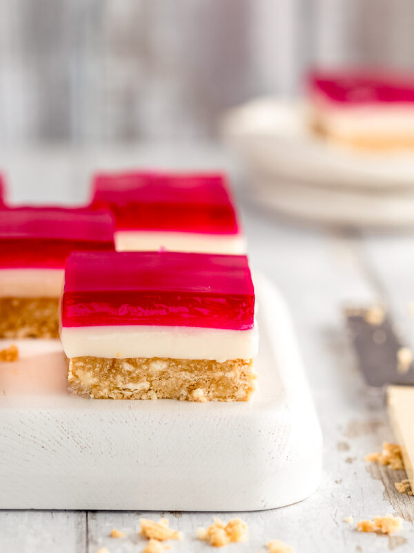 squares of jelly slice on a white wooden tray