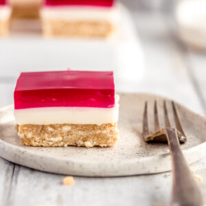 A single serve of jelly slice on a plate, with a vintage fork beside it