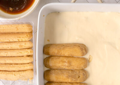 begin the second layer of coffee-dipped lady finger biscuits