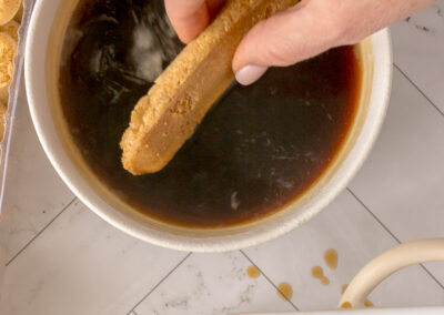 dip a lady finger into the coffee mixture