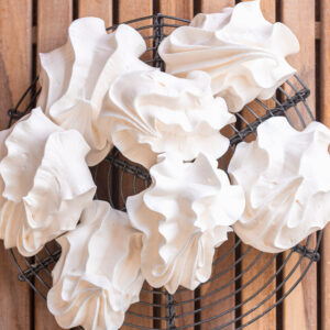 italian meringue cookies on a wooden tray