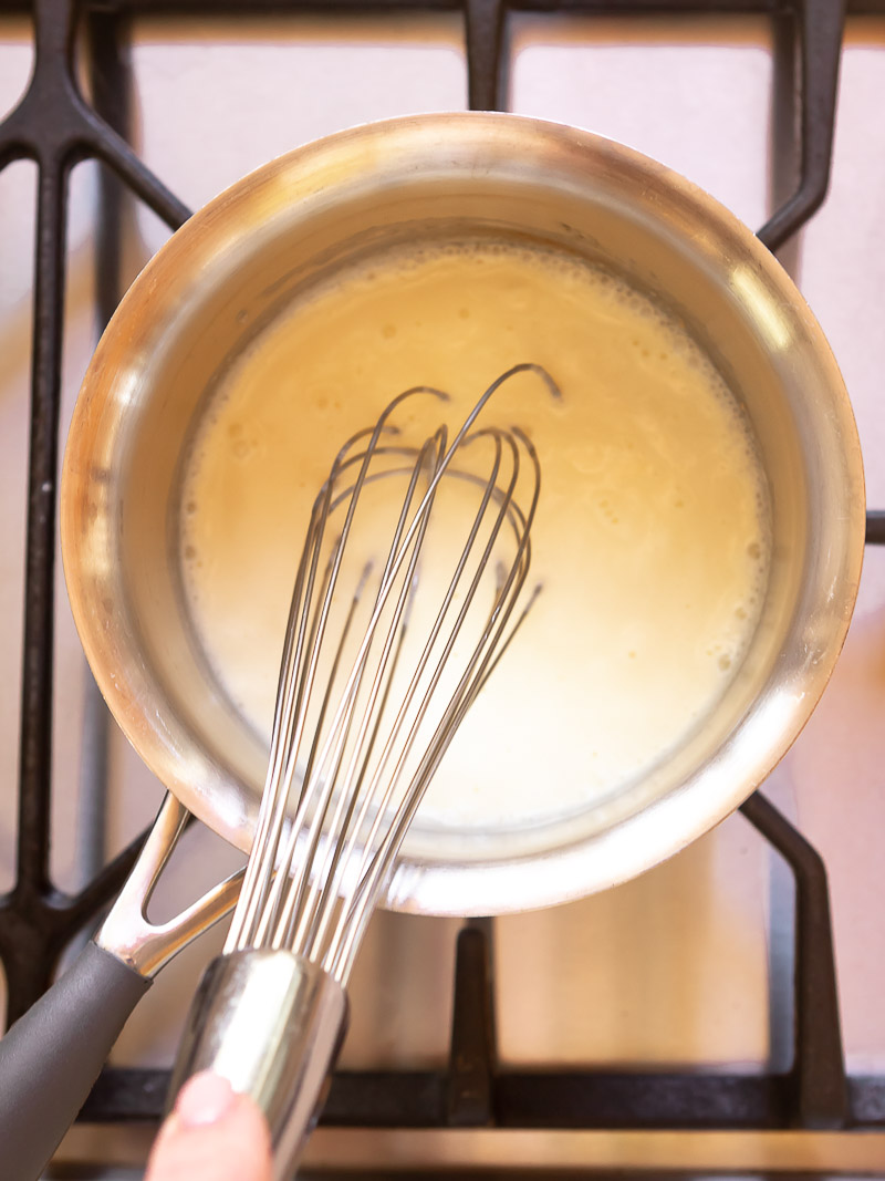 process shot of cream and glucose in a saucepan