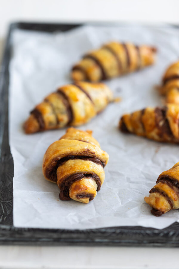 baked chocolate croissants on parchment paper