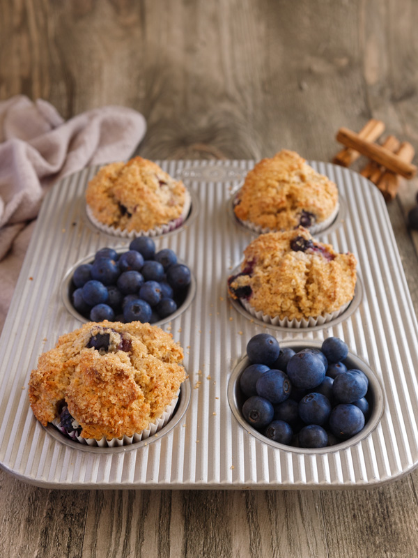 4 blueberry muffins in a muffin tin