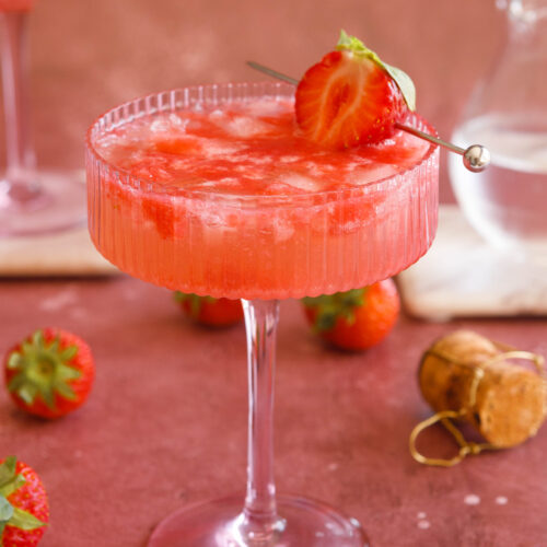 sparkling strawberry cocktail in a pink champagne coup