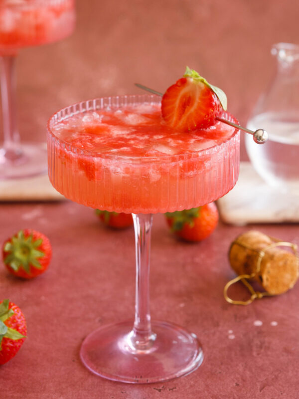 sparkling strawberry cocktail in a pink champagne coup