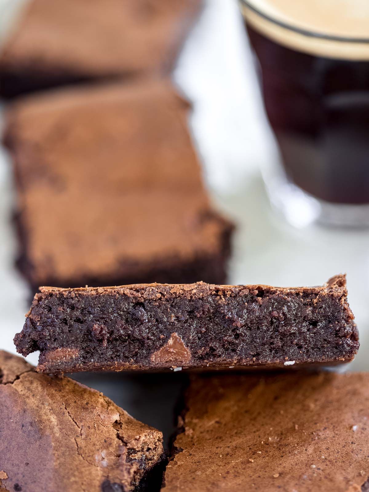 fudgy espresso brownies on a tray with a shot of espresso on the side