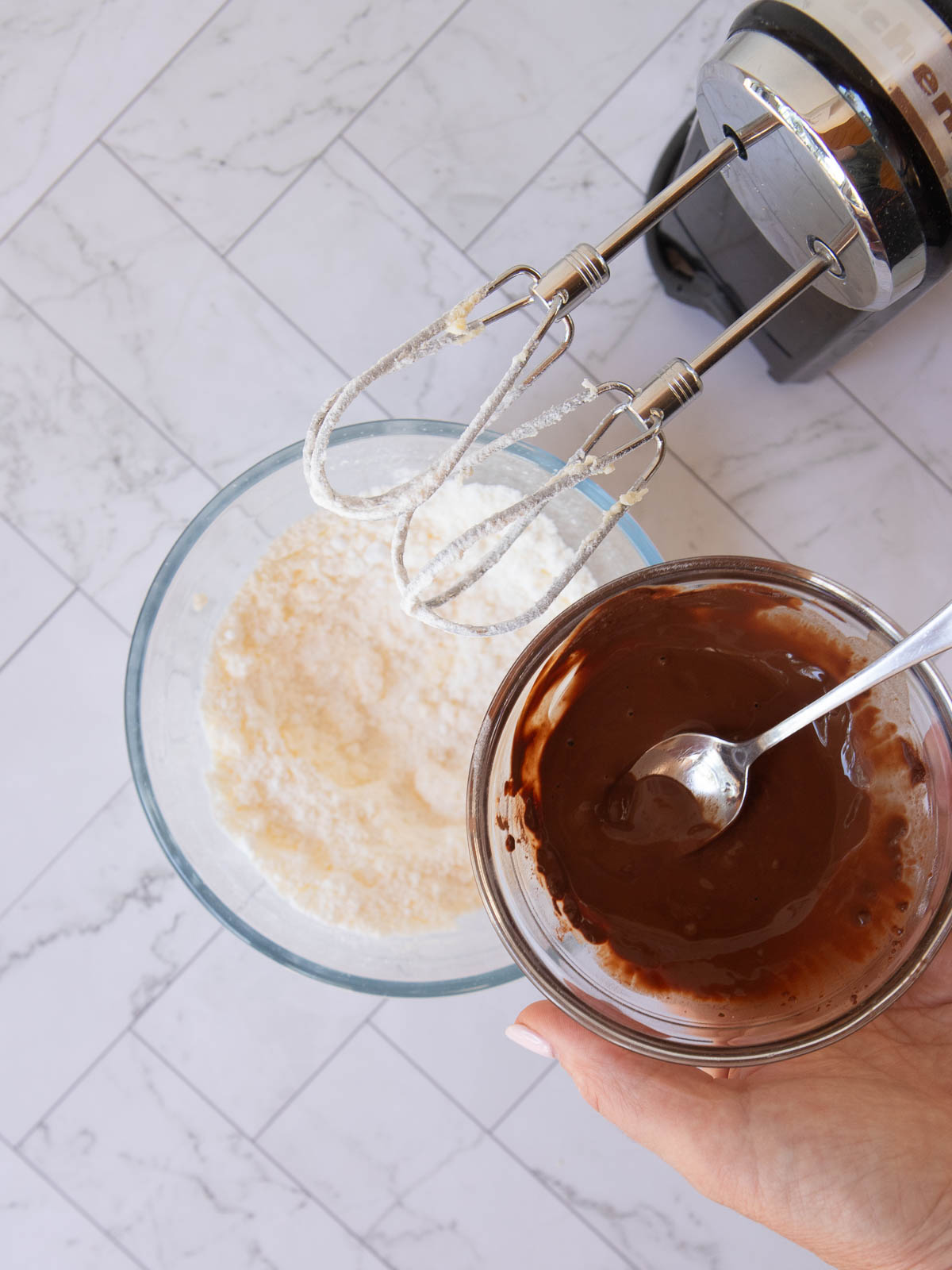 Adding boiling water and cocoa to the icing.