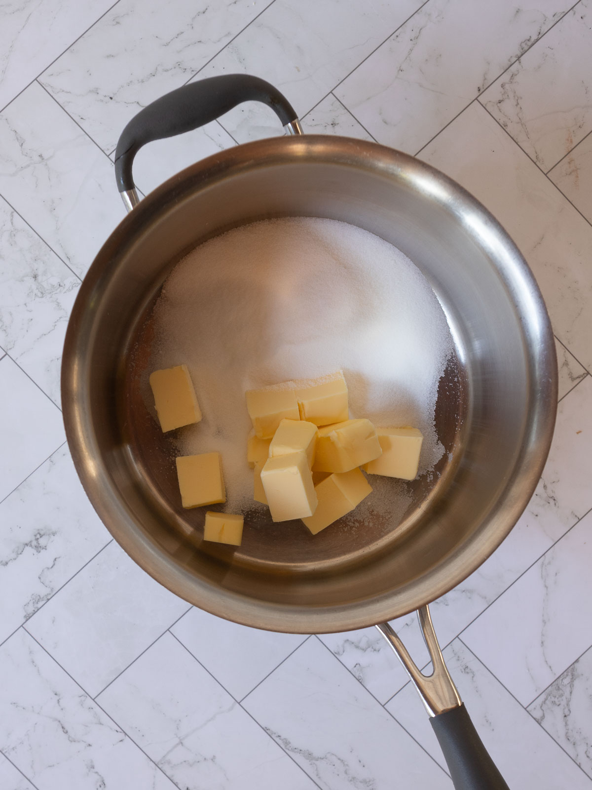 Melting butter and sugar to make Hedgehog Slice