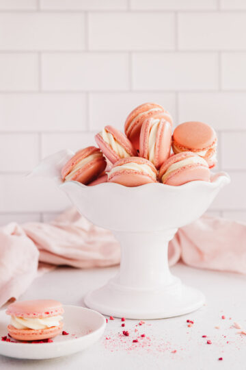 raspberry macarons with white chocolate ganache in a white bowl