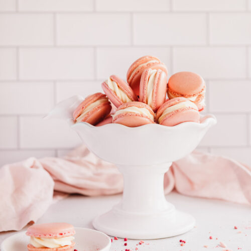 raspberry macarons with white chocolate ganache in a white bowl