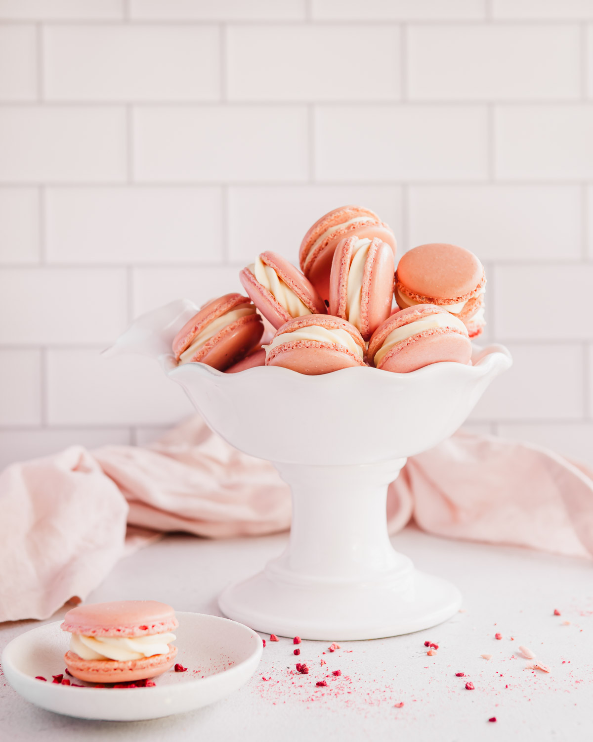 raspberry macarons with white chocolate ganache in a white bowl