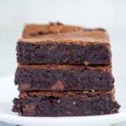 Three rich and fudgy chocolate espresso brownies on a plate