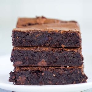 Three rich and fudgy chocolate espresso brownies on a plate